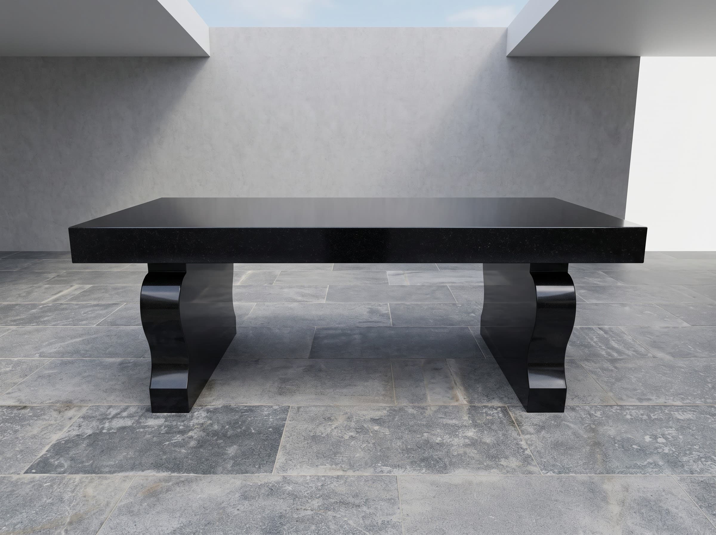 Polished black granite bench with curved legs against a pale wall