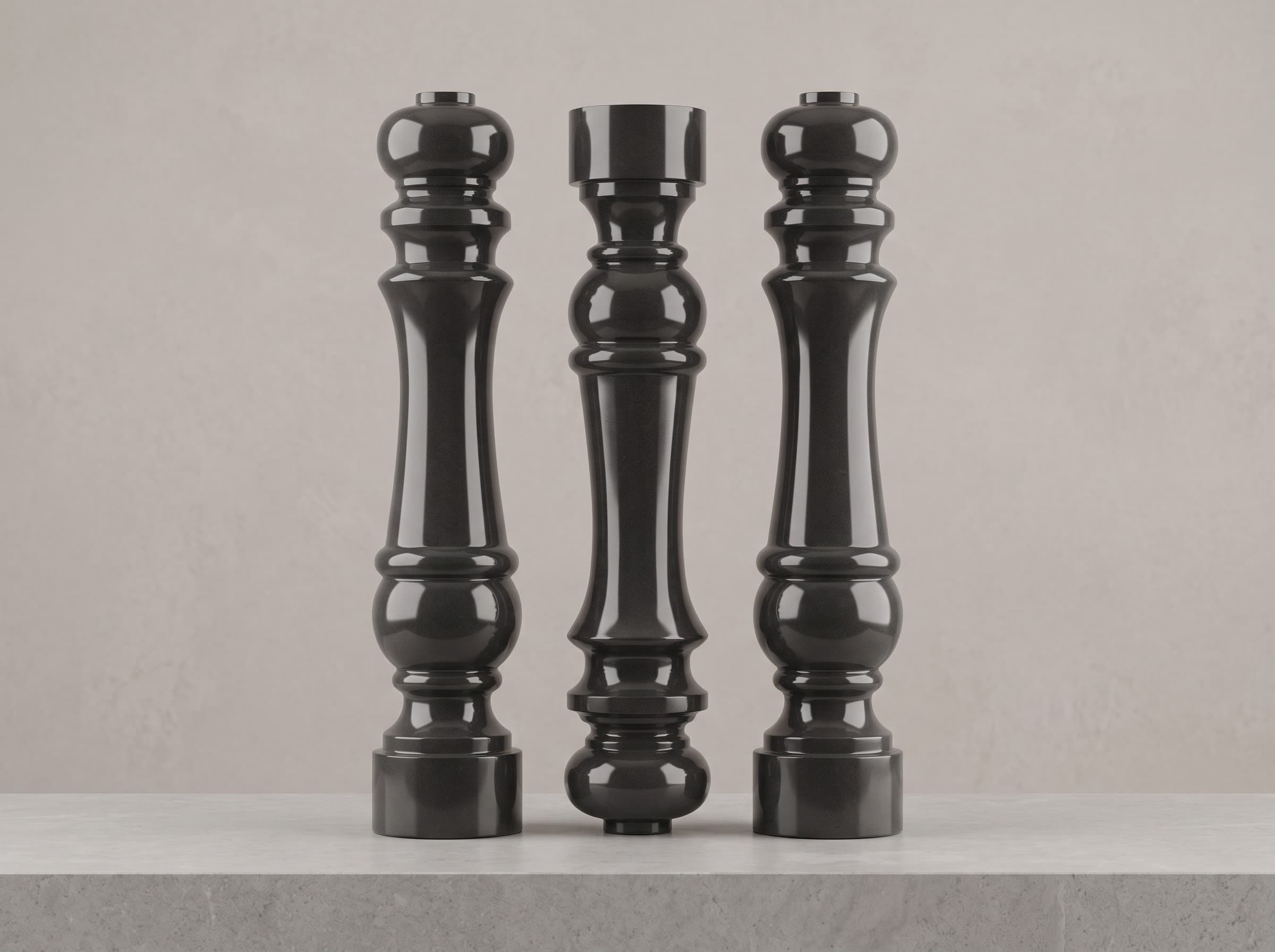 Three turned black granite columns standing side by side
