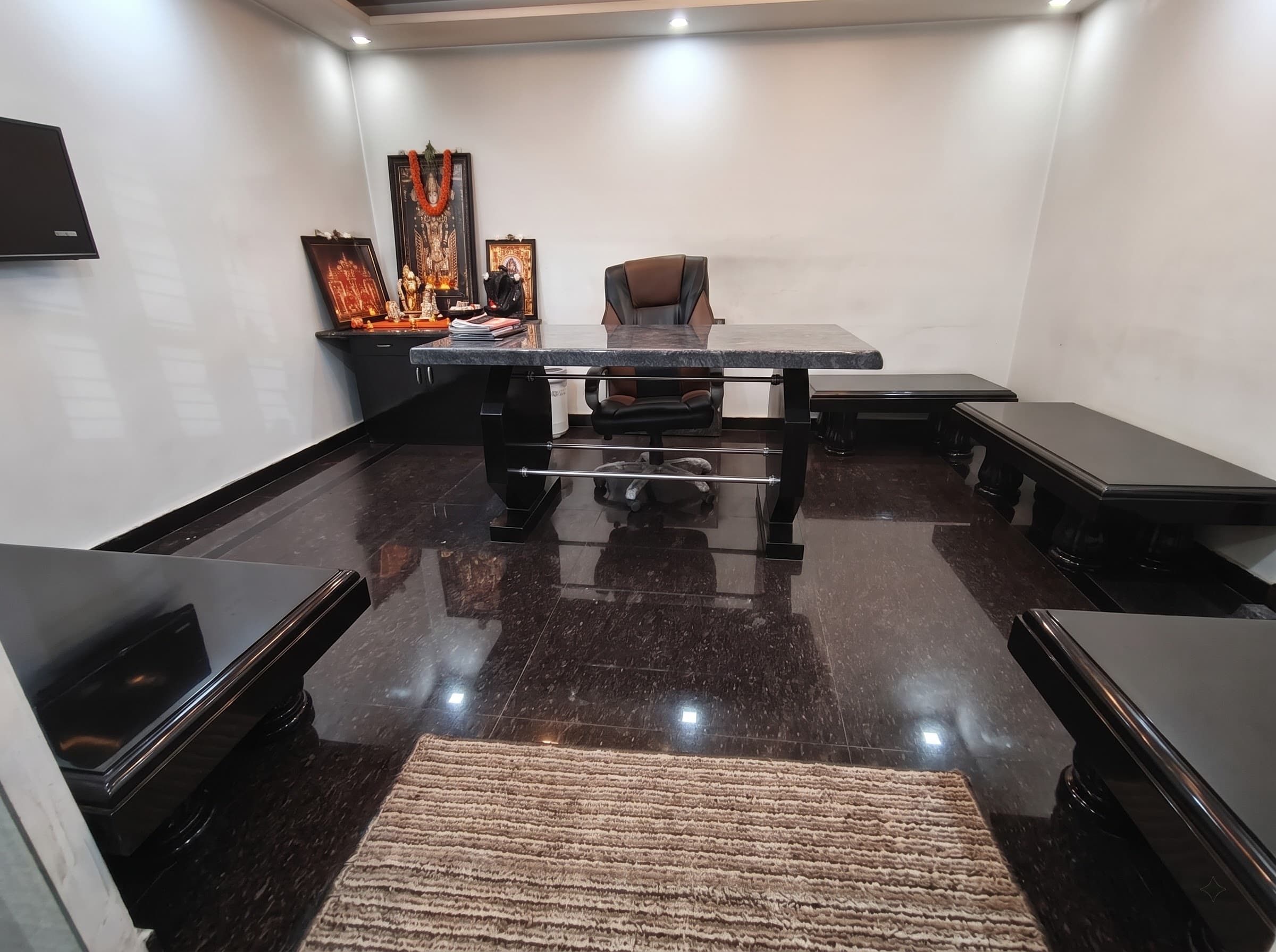 Interior room with polished dark granite flooring and granite furniture