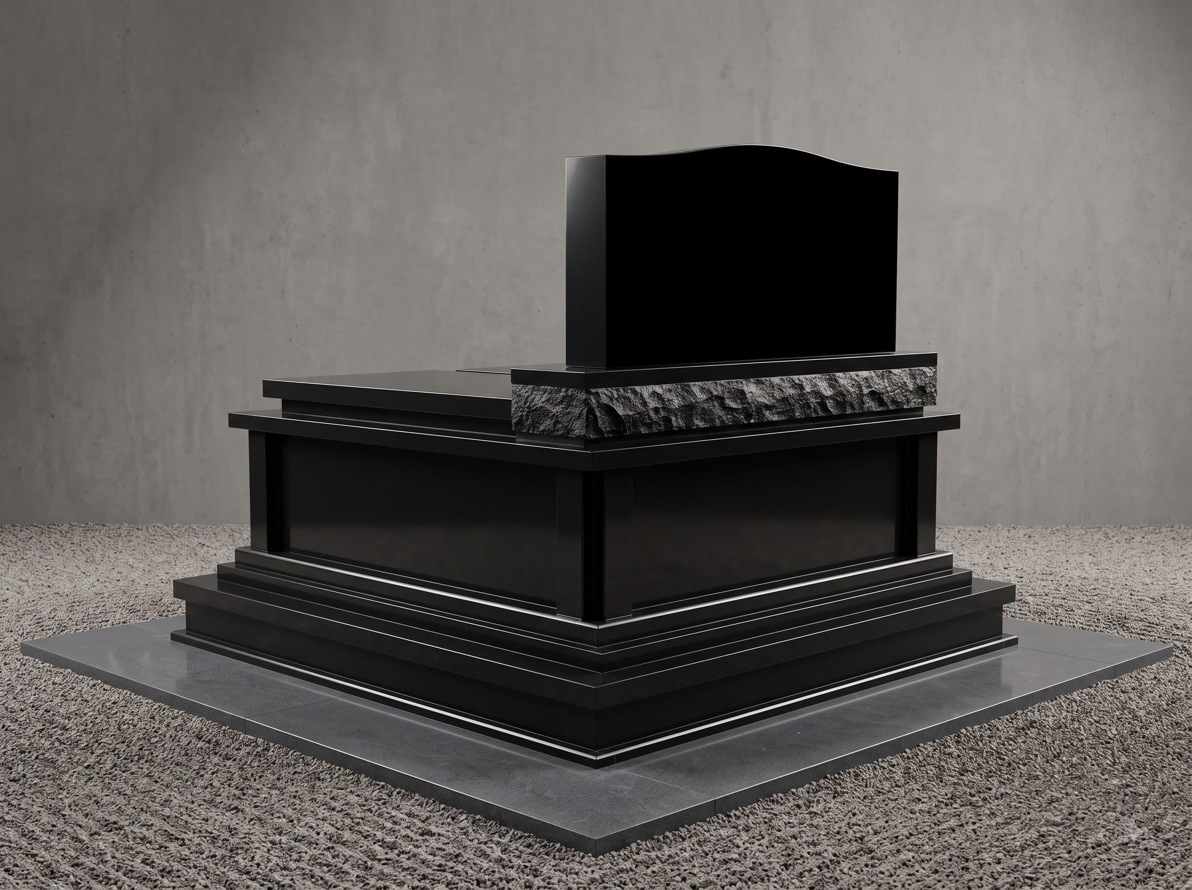 Stepped black granite pedestal monument with a carved textured band